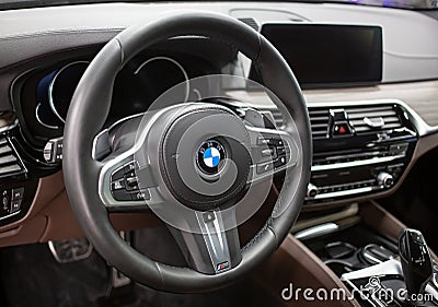 BMW X5 steering wheel and dashboard. Beige leather car interior. Editorial Stock Photo