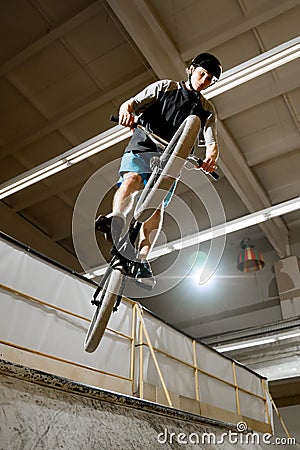 BMX Rider Doing Extreme Tricks on Bike in the Skatepark. Healthy and Active Lifestyle. Stock Photo