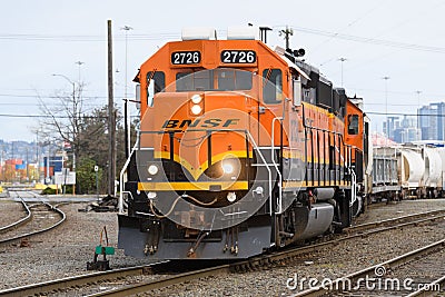 BNSF GP39-2 locomotive moving freight in downtown Seattle Editorial Stock Photo