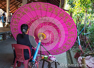 Bo Sang village, handmade umbrellas and parasols, unidentified woman at work at the umbrella making centre Ban Bo Sang, Chiang Mai Editorial Stock Photo