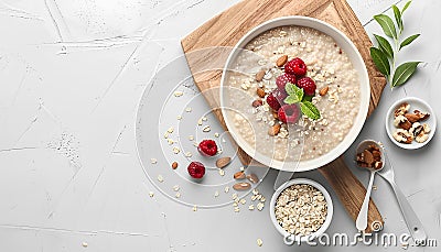 Board with bowl of tasty buckwheat porridge on white table Stock Photo