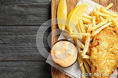 Board with British traditional fish and potato chips on wooden background, top view Stock Photo