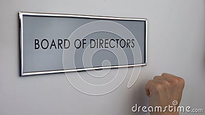 Board of directors office door, hand knocking closeup, general meeting, strategy Stock Photo