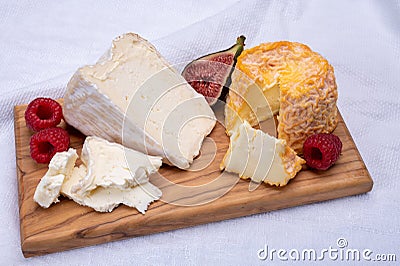 Board with french soft cheeses, Delice de Bourgogne French cow's milk cheese from Burgundy region of France Stock Photo