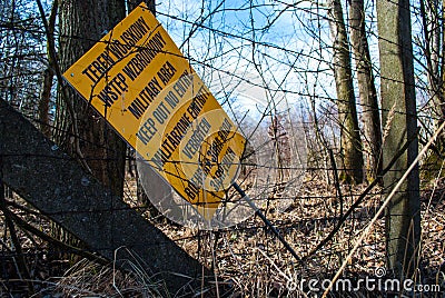 A board informing about an military area abandoned. `Teren wojskowy wstÄ™p wzbroniony` means military area keep out no entry Stock Photo