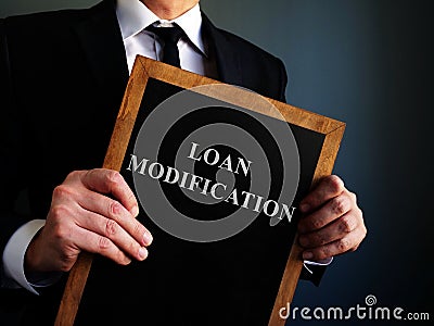 Board with sign Loan Modification in the manager hands Stock Photo