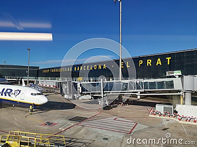 Boarding plane, view from a finger - boarding bridge at the Barcelona Terminal B airport Editorial Stock Photo