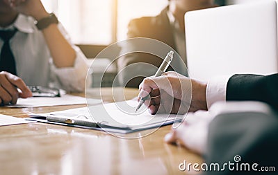 Boardroom with human resource business people writing paper negotiating a contract. Stock Photo