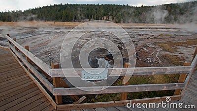 Boardwalk curving around Hot Cascades hot spring in the Lower Geyser Basin in Yellowstone National Park in Wyoming USA Stock Photo