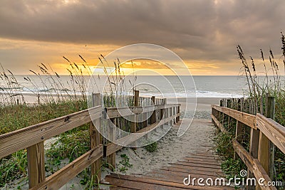 Boardwalk Leading to the Beach at Sunrise Stock Photo