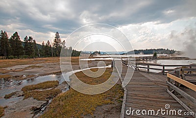 Boardwalk next to Tangled Creek and Black Warrior Springs leading into Hot Lake in Yellowstone National park in Wyoming USA Stock Photo