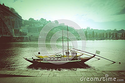 Boat with barrels of wine at the berth. Douro River. city of Porto. Toned Stock Photo