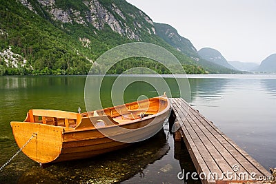 boat berth by the tranquil lake pier with mountain Stock Photo