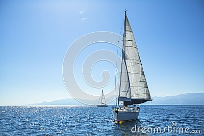 Boat competitor of sailing regatta in clear sunny weather. Stock Photo