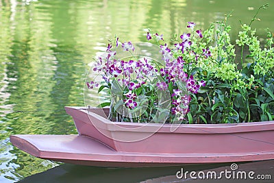 Boat with decoration orchids flower on water at Nong Buak Hard Public Park in Chiang Mai , Thailand Stock Photo