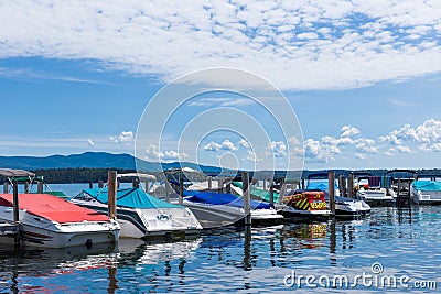 Boat dock on an New England lake on bright cloudy blue day Stock Photo