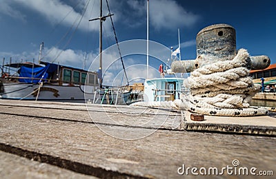 Boat docking point at a marina - rope fixed around a belay Stock Photo