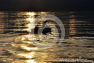 Boat and fisherman in sunset.Boat and fisherman in wonderful sunset at Adriatic sea Croatia-Kvarner Stock Photo