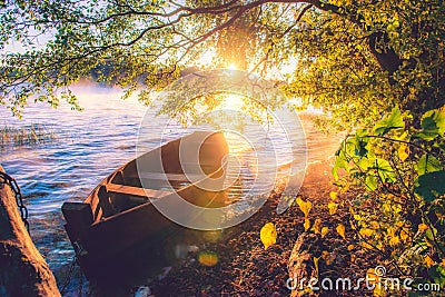 Boat in lake, sunrise Stock Photo