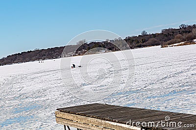 Boat launch ramp at frozen lake with traffic marks on frozen lake surface Stock Photo