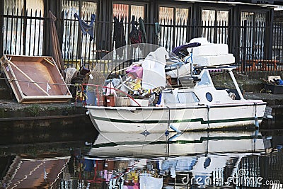 Boat loaded with various junk, standing at Regent canal Editorial Stock Photo