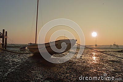 Boat at Low Tide at Sunset Stock Photo