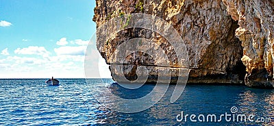Boat on a malt cliff with white sand bottom and turquoise water Stock Photo