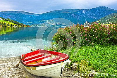 Boat in Norway fjords. Norwegian village Olden. Stock Photo