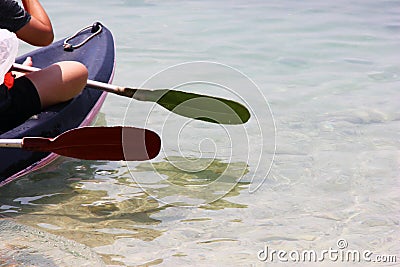 Boat with oars in the clear sea. Rest and travel. Water sport Stock Photo