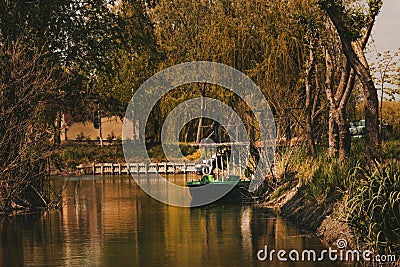 Boat at the pier on the lake quiet place outside the city trees around the river nature Stock Photo