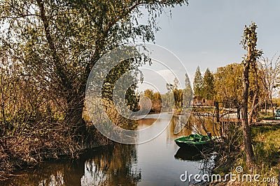 Boat at the pier on the lake quiet place outside the city trees around the river Stock Photo