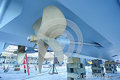 Boat propeller up on blocks in boat yard Stock Photo