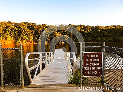 Boat Ramp Overlooking The Raritan River With Warning Sign Stock Photo