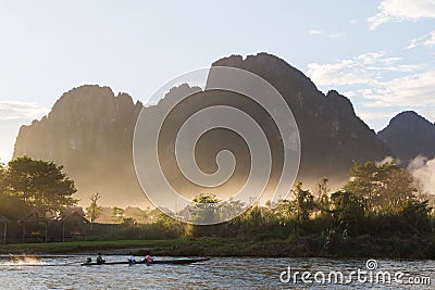 Boat in River with Mountain in background Stock Photo