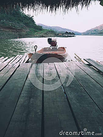 A boat with a rudder moored at the raft Stock Photo