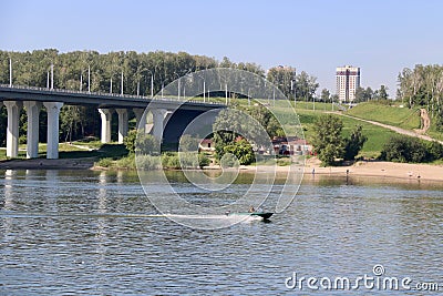 The boat rushes under the bridge Stock Photo