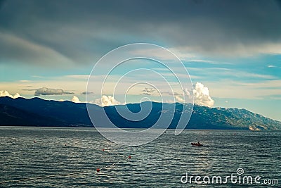 A boat sailing into the sea after the rain Stock Photo
