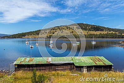 Boat shed on a bay overlooking boats on the water Editorial Stock Photo