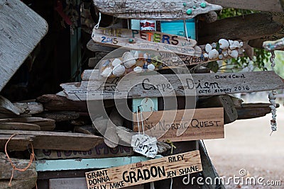 Boat signs and name plates with shells decorating a driftwood hut in Canada`s Inside Passage Stock Photo