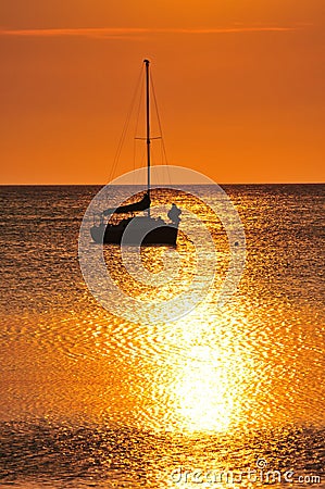 Boat silhouetted at sunset Stock Photo