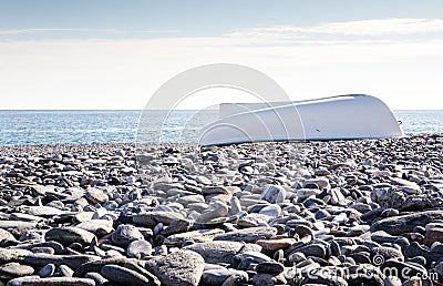 Boat on stony beach Stock Photo