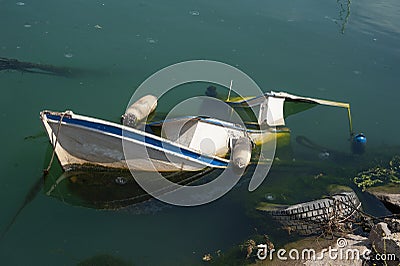 Boat submerged and abandoned due to neglect Stock Photo