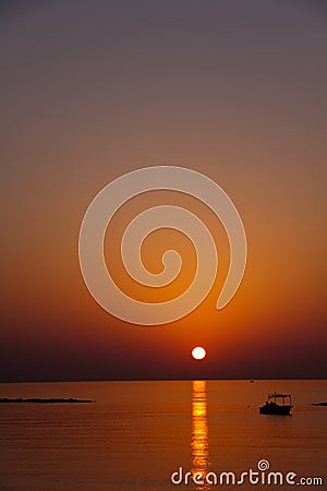 Boat , sunset at beach in Cyprus Stock Photo