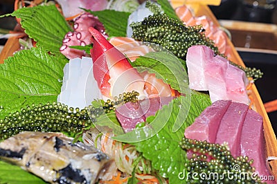 A boat of sushi with tuna, salmon, green caviar and octopus Stock Photo