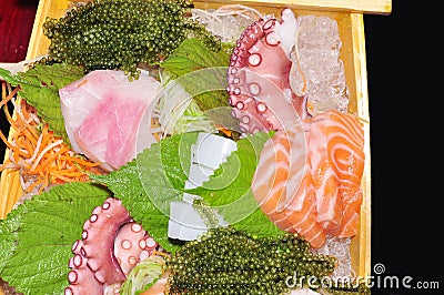 A boat of sushi with tuna, salmon, green caviar and octopus Stock Photo