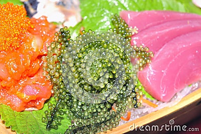 A boat of sushi with tuna, salmon, green caviar and octopus Stock Photo