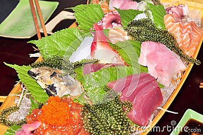 A boat of sushi with tuna, salmon, green caviar and octopus Stock Photo