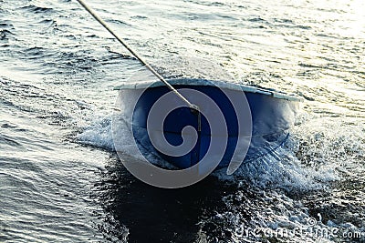 Boat is tethered behind fishing schooner Stock Photo