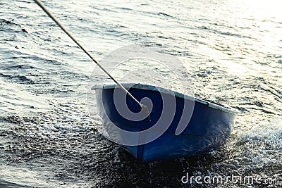 Boat is tethered behind fishing schooner Stock Photo