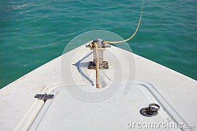 Boat is tied with a rope to the pier. View of the fore deck of the boat Stock Photo